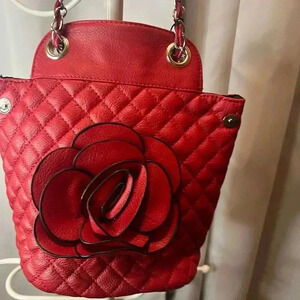 Victoria Leland designs red quilted rosette crossbody bag